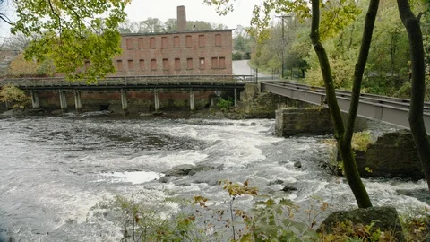 Old abandoned building next to stream and bridge Stock Footage 109425435