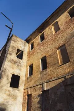 An old, abandoned building with no windows. Evening light on an building Stock Photos