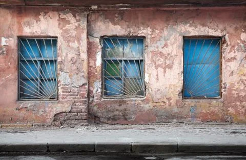Old abandoned building wall texture with blue windows Fotos de archivo