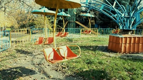 An old abandoned carousel turns in the park in the sunlight Stock Footage 106401358