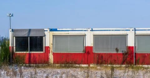 Old abandoned container building with windows in the middle of nowhere Stock Photos