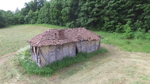 Old abandoned cottage next to the forest in the meadow Stock Footage 111253537