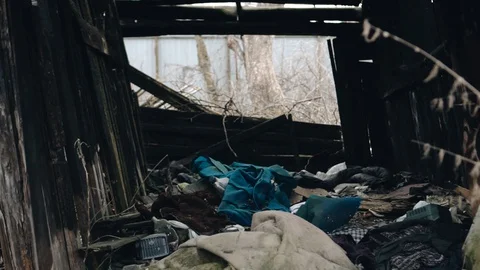An old abandoned dilapidated building. There's a lot of junk lying around Stock Footage 128016737