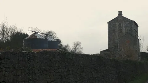 An old abandoned grain mill beside a river in rural Ireland. Wide 4k Stock Footage 149021516