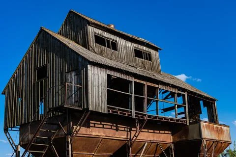 Old abandoned grain storage current against the blue sky Stock Photos