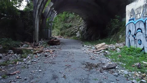 An old abandoned highway in the mountains, river. Aerial view from drone. Stock Footage 220574774