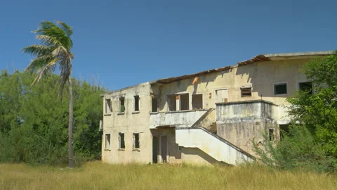 Old abandoned hotel crumbles down in the rugged tropical elements on Barbados. Stock Footage 132719756