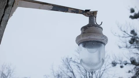 Old abandoned lantern, flaky, peeling paint. Apocalypse. Snowy winter Stock Footage 103859341