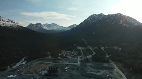 Old Abandoned Mine Site surrounded by Mountains, Drone View Stock Footage 289486079