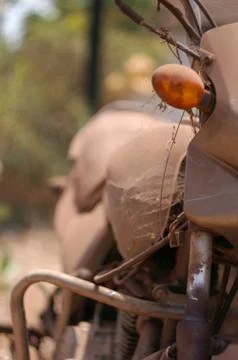 Old abandoned motorcycle with rusty components in the dust Stock Photos