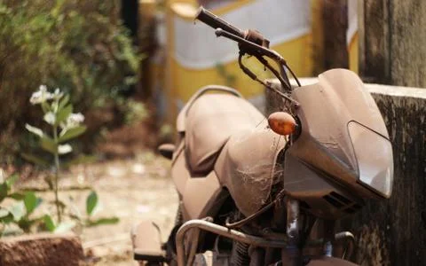 Old abandoned motorcycle with rusty components in the dust Stock Photos