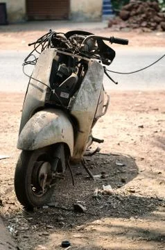 Old abandoned motorcycle with rusty components in the dust Stock Photos