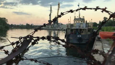 An old abandoned pier with a ship. And barbed wire. Stock Footage 160500102
