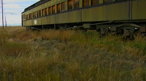 An old abandoned Pullman railway car sits in a field on a Stock-Footage 556845