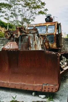 Old abandoned rusty broken tractor. Tractor in a landfill. Stock Photos