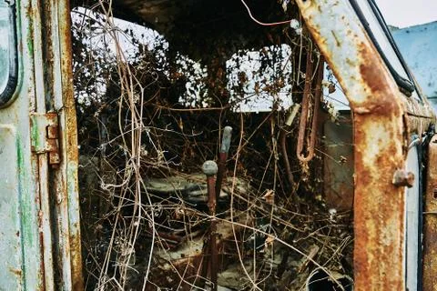 Old abandoned rusty broken tractor. Tractor in a landfill. Stock Photos