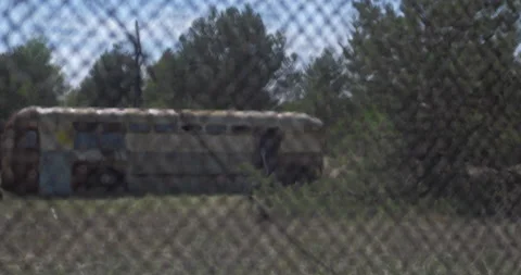 Old abandoned rusty Soviet bus behind a fence Stock Footage 200948518