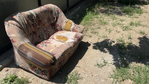 Old abandoned sofa outdoors next to garbage. Stock Footage 344974856