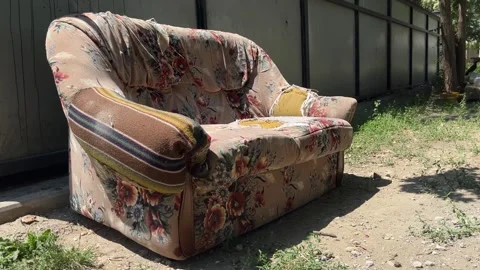 Old abandoned sofa outdoors next to garbage. Stock Footage 344974964
