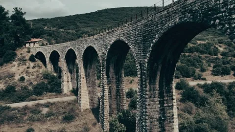 Old abandoned stone train bridge over the river Vidéo 346486809