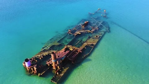 Old abandoned stranded ship lying in clear turquoise sea after crush. Stock Footage 138586431