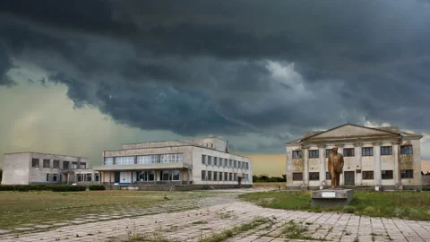Old abandoned town square with  soviet symbolics under a dense cloudy Stock Footage 148835972