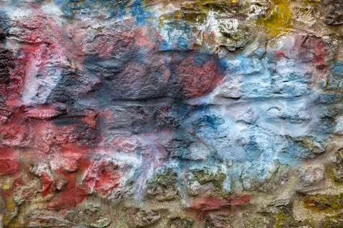 Old abstract red blue multi coloured painted stone brick wall texture Stock Photos
