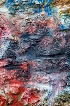 Old abstract red blue multi coloured painted stone brick wall texture 스톡 사진