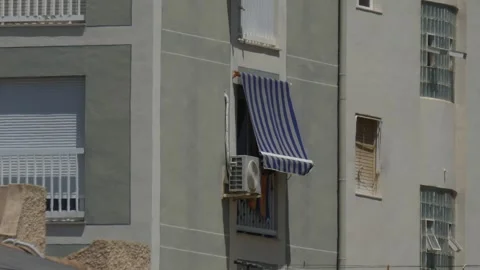 Old AC on a window with an old tent curtains Stock-Footage 314936367