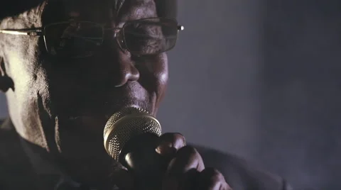 Old African black colored man singing microphone dark face Stock Footage 54800344