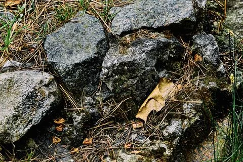 Old aged destroyed granite wall made of stones Stock Photos