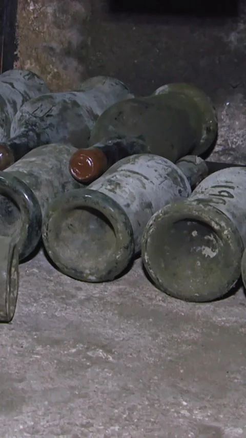 Old Aged Wine Bottles Storage in Dark Rustic Cellar Basement, Stack of Lying Dir Stock Footage 248878247