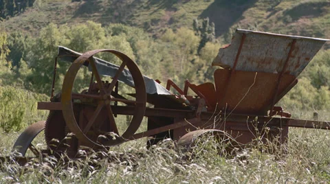 Old agricultural implement abandoned in a field Stock Footage 32326390