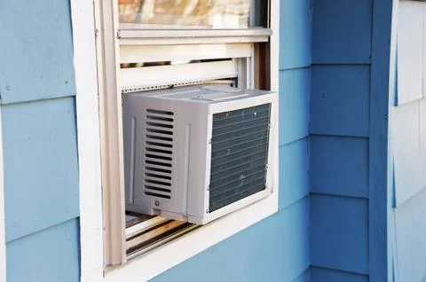 Old air conditioner installed on window Stock Photos