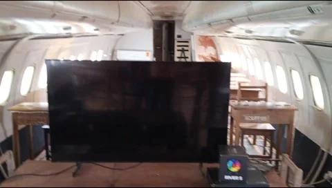 Old airplane converted into ICT classroom at the Red clay studio in Ghana Stock Footage 336590989