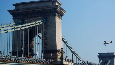 An old airplane fly over Chain bridge at Budapest Stock Footage 103166356