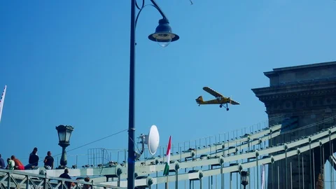 An old airplane fly over the Chain bridge at Budapest, Danube Stock Footage 103166555