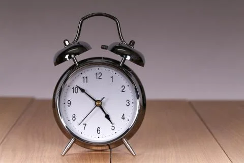 The old alarm clock on a light background Stockfoto's