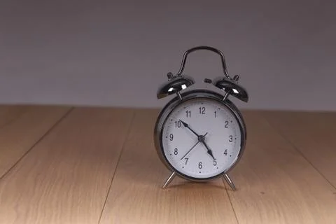 The old alarm clock on a light background Stock Photos