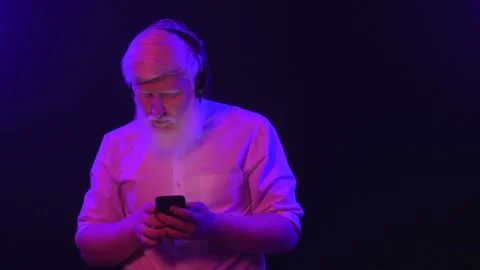 An old albino grandpa dancing while wearing new earphones and changing songs  Stock Footage 137515333