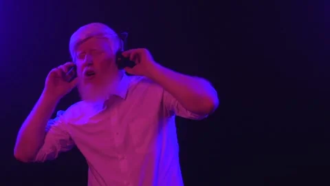 An old albino grandpa dancing while wearing new earphones, isolated on a cool Stock Footage 137515889