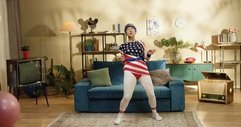 Old American grey-haired pretty woman dancing in living room. Senior Caucasian Stock Footage 126672897