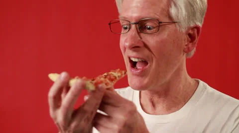 Old American man eats the oven-baked flat bread Stock Footage 22753181