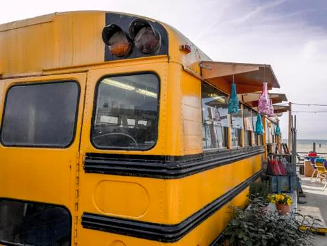 Old american schoolbus turned into beach bar Stock Photos