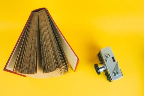 Old analog camera with red book, concept of learning photography history of p Stock Photos