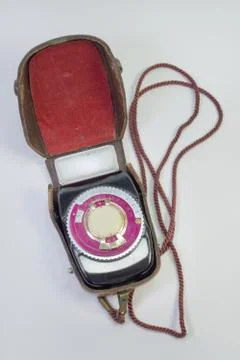 Old analog light meter in leather case on strap Stock Photos