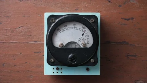 Old analog voltmeter with a metal arrow. The voltmeter arrow moves randomly. Stock Footage