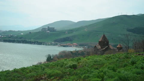 Old ancient Monastery church by Sevan Lake in Armenia. Summertime windy day Stock Footage 195290660