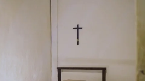 Old ancient simple room or prison cell with a bed and a christian cross 動画素材 84027721