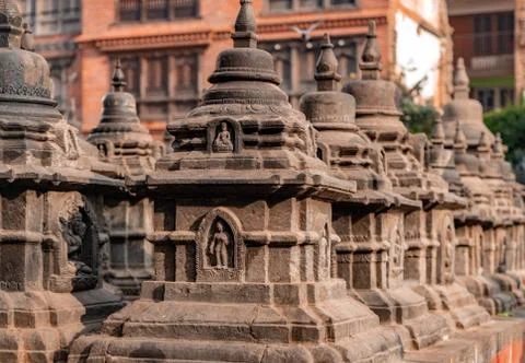Old ancient stone structures with intricate details of statue of Hindu Gods a Stock Photos